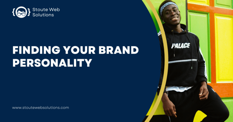 A black male model wearing a black sports jacket and pants leaning on colorful wall.